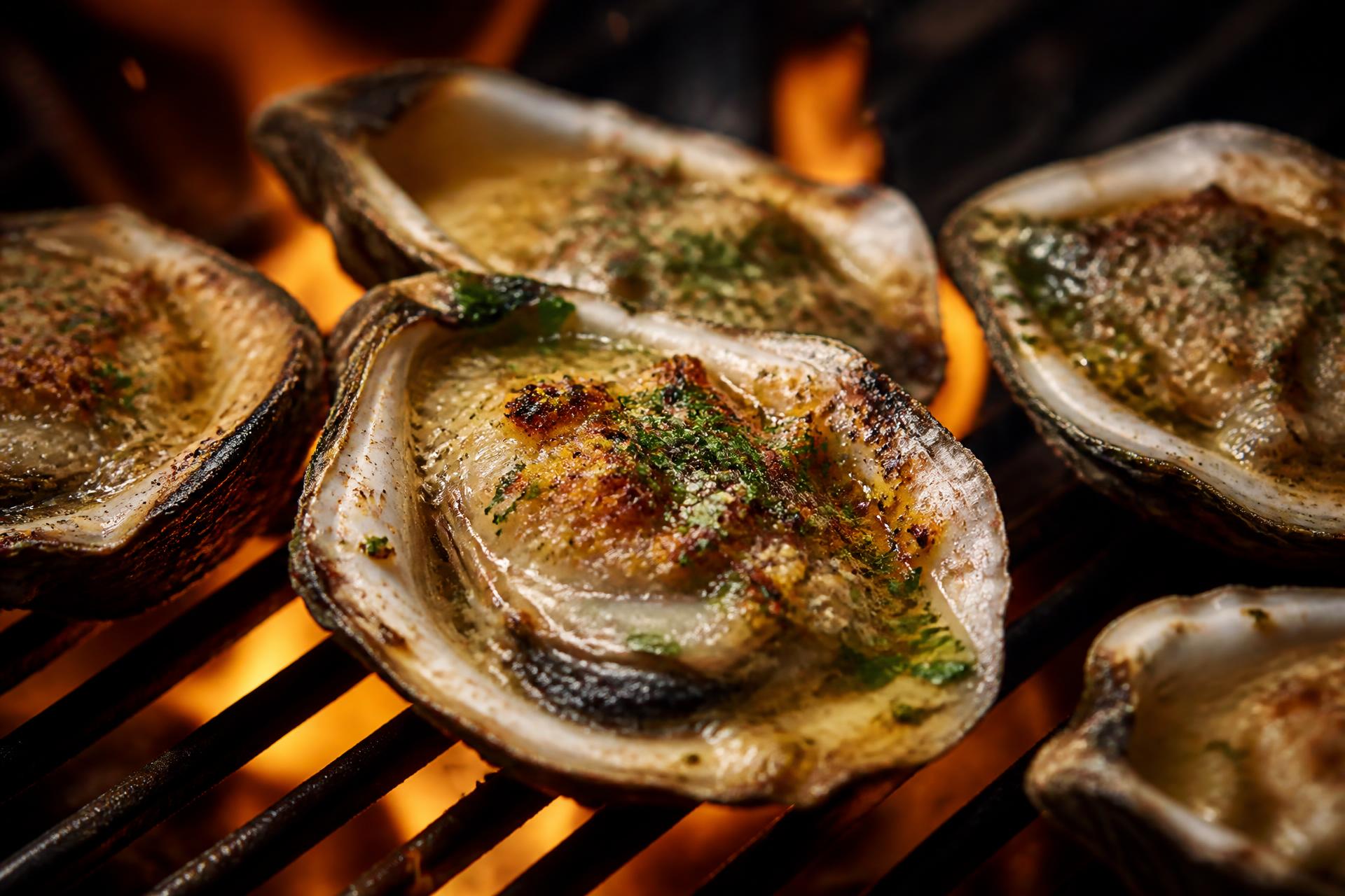 Char-grilled oysters sizzling over an open flame